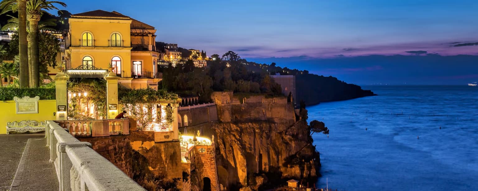 Independent luxury clifftop hotel at dusk, illustrating GEO for hotels and AI hotel visibility