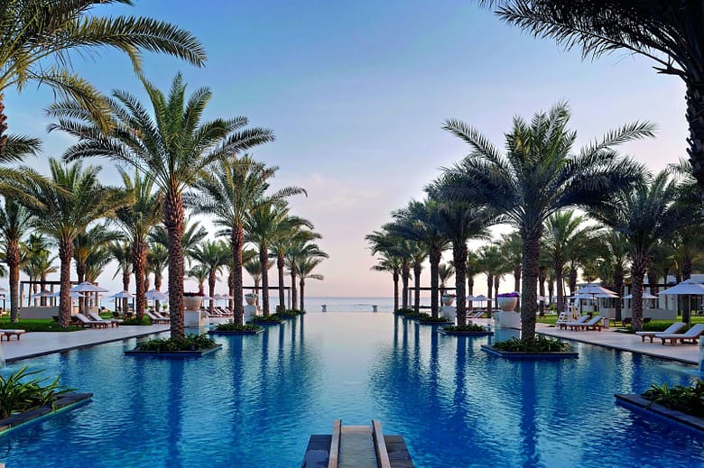 Luxury resort pool with guest amenities and scenic view