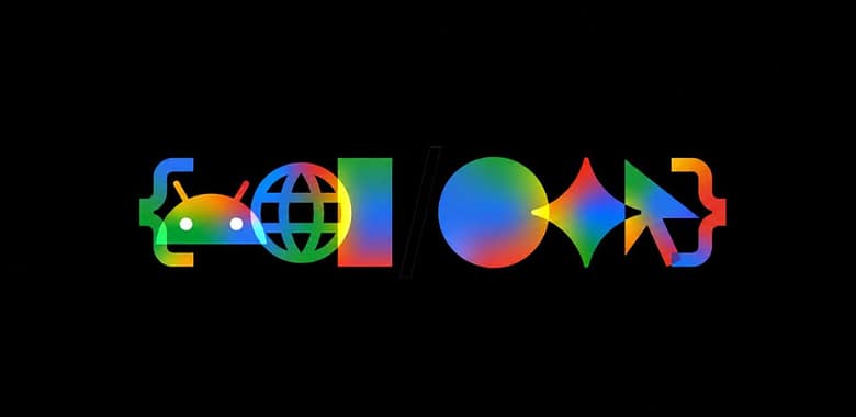 Google I/O 2026 official event graphic on a black background featuring the Android mascot, a globe, geometric shapes, the Gemini spark logo, a cursor, and code brackets rendered in multicolor gradient.