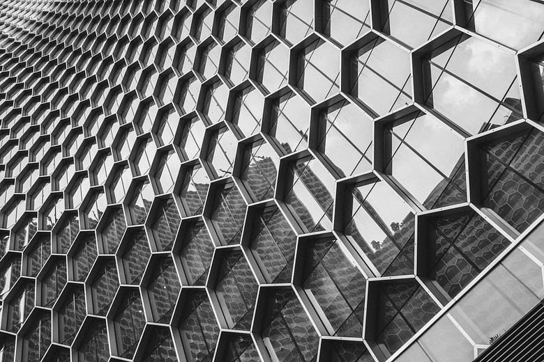 Abstract black-and-white architectural facade with repeating geometric window pattern