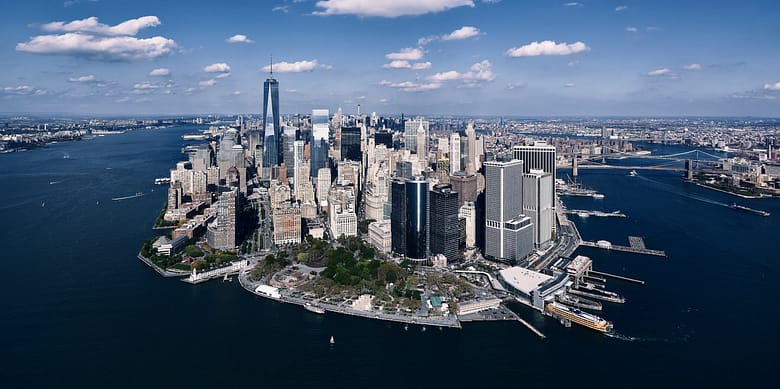 Aerial view of lower Manhattan financial district, illustrating the executive and ownership-level economics of luxury hotel guest acquisition and OTA commission costs.
