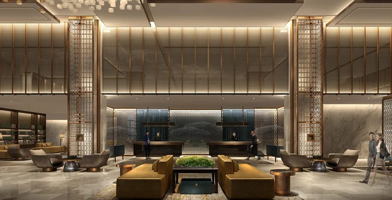 Grand luxury hotel lobby interior with double-height ceilings, marble walls, and reception desk, illustrating the high-stakes economics of rate parity and direct booking strategy in independent luxury hospitality.
