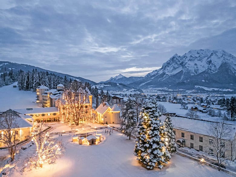 Snow-covered luxury resort at dusk, representing the guest experience highlighted in direct-booking email marketing.