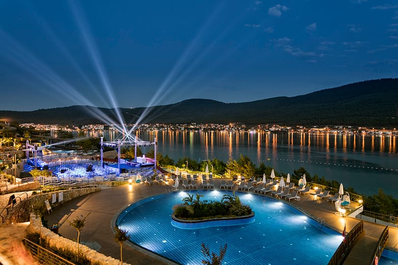 Luxury resort pool with guest amenities and scenic view