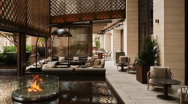 Aman New York garden terrace with fire pit and reflecting pool at the Crown Building, the best hotel in New York City