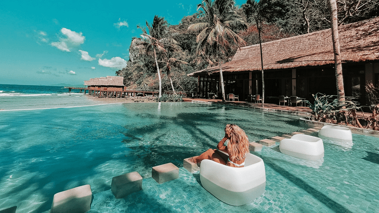 Luxury resort pool with guest amenities and scenic view