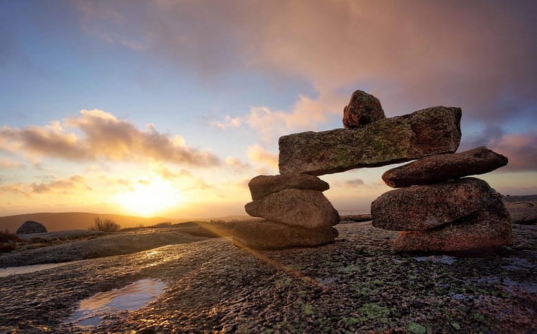 AEO vs GEO vs KFO - three layers of AI visibility strategy represented as stacked stones at sunset