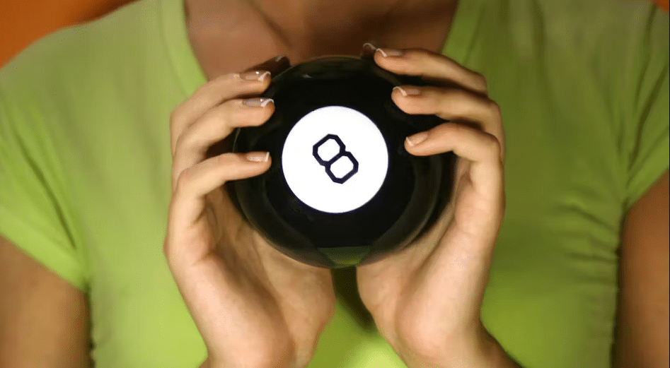 Person holding a Magic 8 Ball, representing future predictions and uncertainty in the resort industry