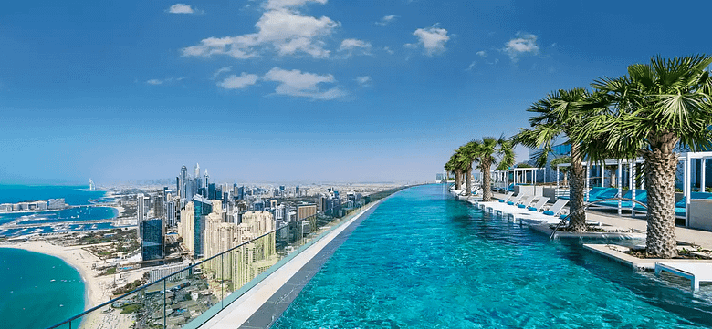 Luxury resort infinity pool overlooking a modern coastal skyline – ideal imagery for hotel email marketing and 2026 luxury travel trends