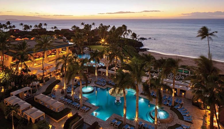 Luxury resort pool with guest amenities and scenic view